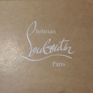 Christian Louboutin White Logo on Tan Background